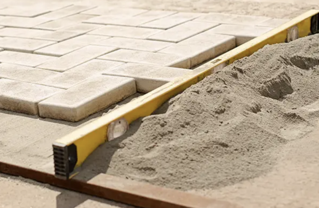 sharp sand being used in paving slabs